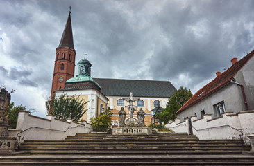 Fototapeta na wymiar Baroque sculpture on the steps of the church in Grodowcu, Poland.