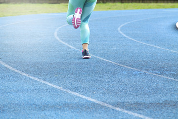 Woman running on track