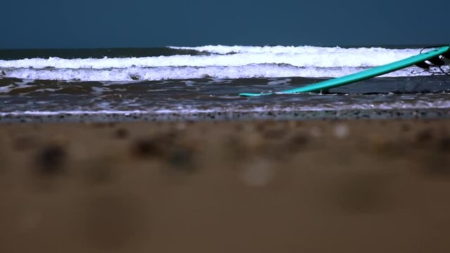 Surfer walking with long surf boards on beach