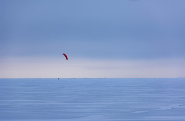 kiteboarding, kajtserfingom skating on the frozen Finnish Gulf i