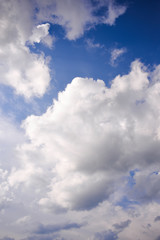 Bright dark blue sky with dramatic clouds. Aerial sky and clouds background. Image of white fluffy clouds in the blue sky for background usage