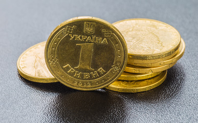 Coins of Ukraine stack on black.