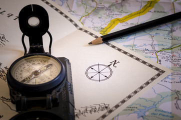 studying old maps, still life with compass and old and new maps. direction. travel. symbol