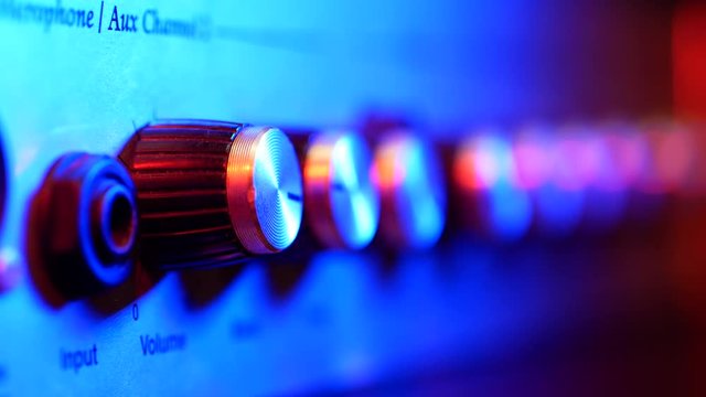 Woman's Hand Turns Up Volume on Vintage Amp