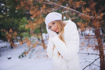 Young model girl walk in the winter forest.