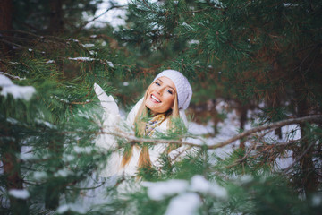 Happy young girl in the winter forest.
