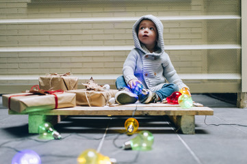 .Little boy decorating home for Christmas