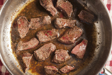 beef pieces browning in a pot