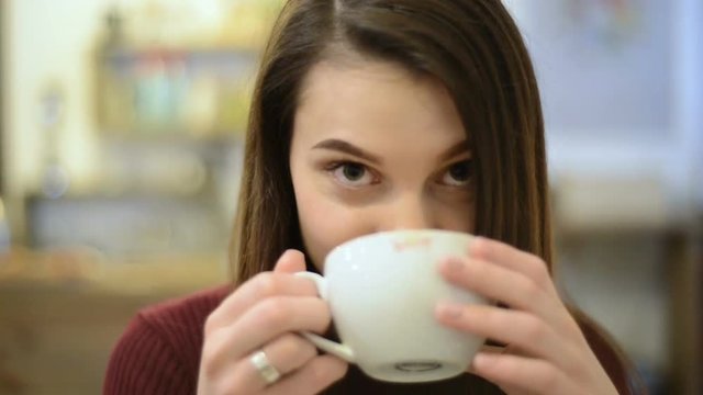 young woman drinks coffee