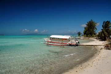 Boat anchored in tropical island beach 