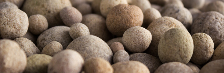 Obraz na płótnie Canvas Sea stones on the beach, background. Sea pebbles.