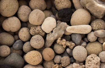 Fototapeta na wymiar Sea stones on the beach, background. Sea pebbles unusual shape.