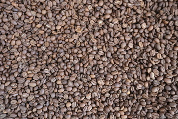Roasted brown coffee beans background, above view. Coffee beans texture