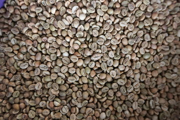 Roasted brown coffee beans background, above view. Coffee beans texture