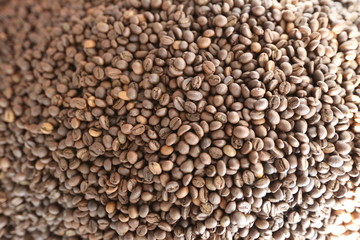 Roasted brown coffee beans background, above view. Coffee beans texture