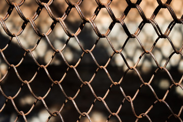 Fototapeta premium Metallic rusty fence in a grid background