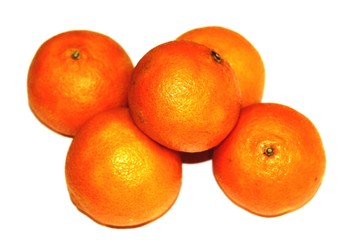 Bright yellow tangerines lie on a white table