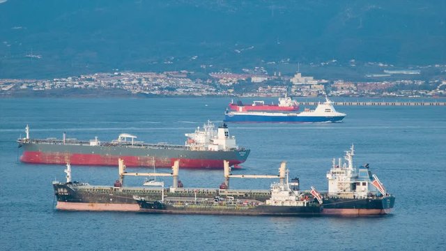 Generic Tanker Cargo Ships in Bay of Gibraltar Calling at the Port during Transit of of the Strait with Algeciras Spain in the Background