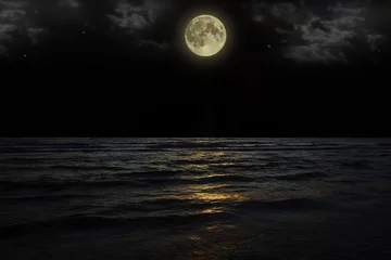Beautiful magic blue night sky with clouds and full moon  stars  reflexion in water © volhavasilevich