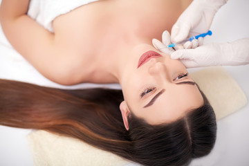 Obraz na płótnie Canvas Woman Having Injection In Lips As Beauty Treatment