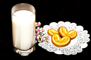 Cookies and a glass of milk - healthy breakfast. Wooden table.