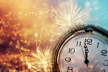 Fototapeta na wymiar Abstract background with fireworks and clock close to midnight