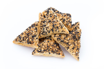 Crisps with nuts and seeds stacked on a white background.