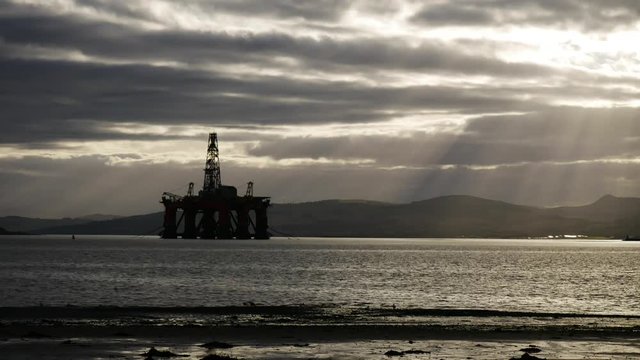 Timelapse of Silhouette of Semi Submersible Oil Rig and Big Boat at Cromarty Firth in Invergordon, Scotland (4K Timelapse)
