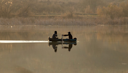 Fototapeta na wymiar fishing boat on the lake at sunset