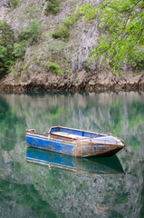 Boat floating on calm lake water