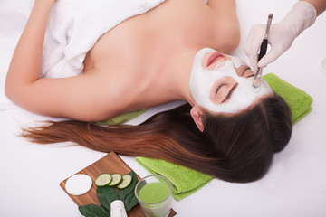 Obraz na płótnie Canvas young beautiful woman with facial mask, spa treatment