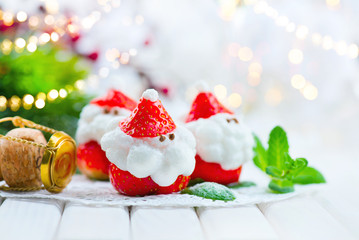 Christmas strawberry Santa. Funny dessert stuffed with whipped cream. Xmas party food idea