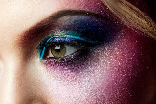Female eye close-up, creative make-up. Purple tones