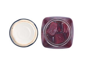 Cut beets in vinaigrette in jar isolated on white background