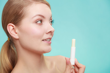 woman applying balsam for lips