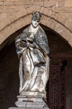 Statue of a bishop in front of the Cefalu Cathedral in Cefalu, Sicily, Italy