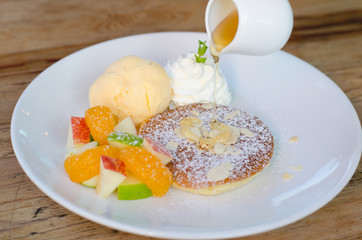 Mixed fruit pancake with ice cream and honey