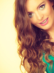 Portrait, young woman wearing colorful makeup and blue top