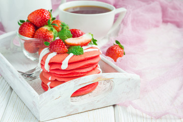 Stack of red velvet pancakes with yogurt and strawberry on on wooden tray, horizontal, copy space
