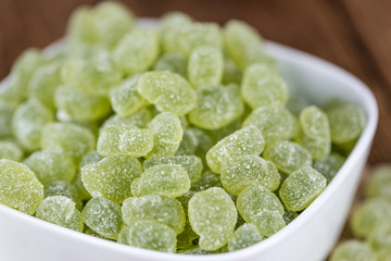 Wooden table with sour gummy candy