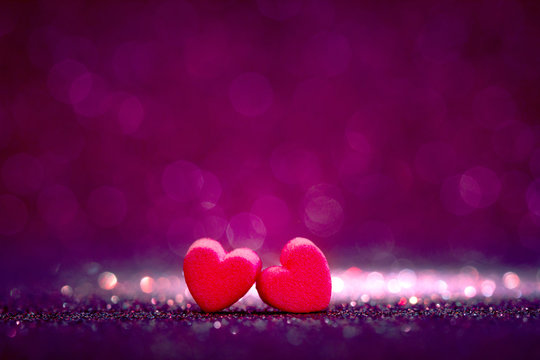 red Heart shapes on abstract light glitter background
