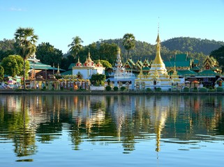 Golden pagoda of Wat Chong Klang and Wat Chong Kham with reflect