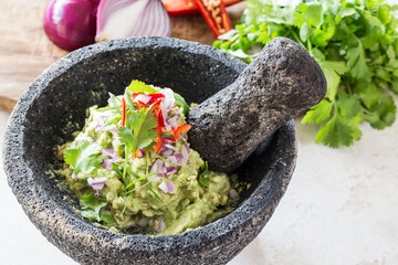 Guacamole/Guacamole in the Molcajete (Traditional Mexican version of the mortar and pestle.