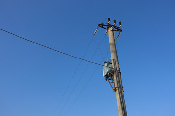 Old electricity pole and blue sky