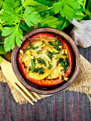 Fish baked with tomato in clay bowl on board top