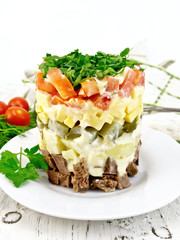Salad with beef and tomato on board