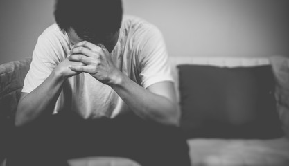 desperate asian man sitting on seat. feel sad, headache, alone at night
