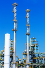 Refinery tower in petrochemical industrial plant with cloudy sky