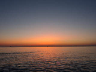 Fiery sunrise at Italian beach. Summer season. Emilia Romagna region. Adriatic sea. Italy