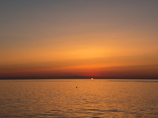 Fiery sunrise at Italian beach. Summer season. Emilia Romagna region. Adriatic sea. Italy
